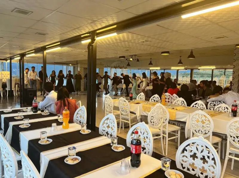 Banquet seating in the Terrace Hall, with guests dancing in the background